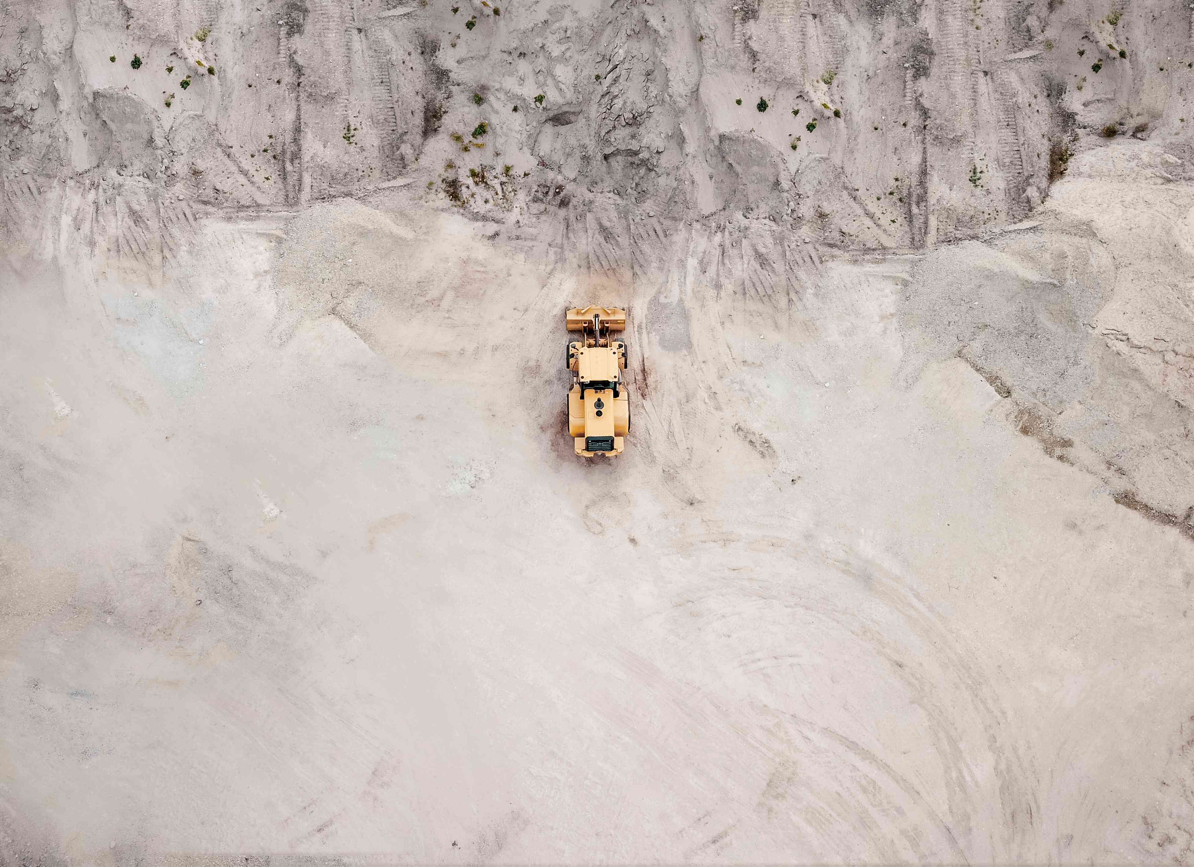 Aerial View Of Bulldozer On Sand