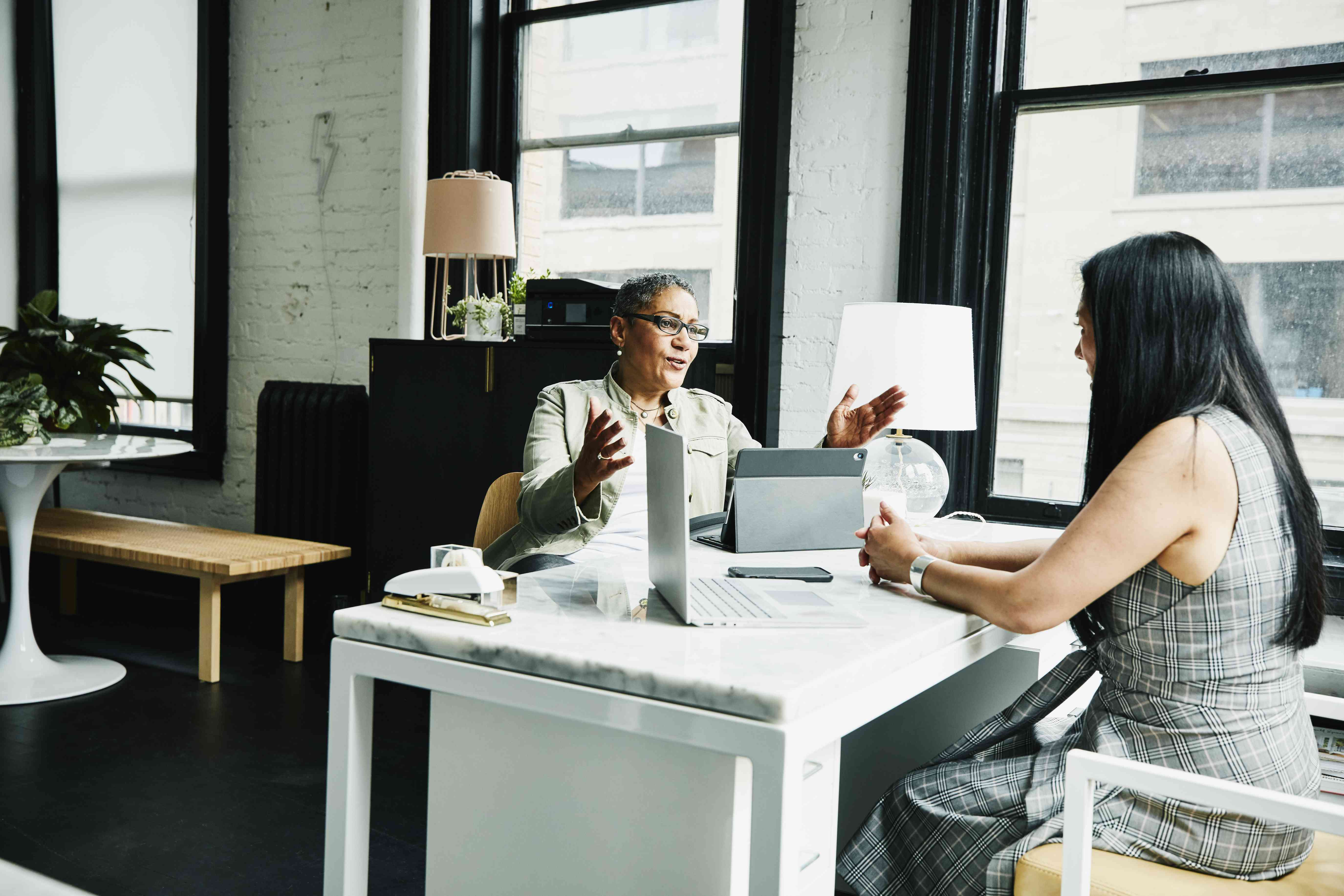 Woman talks to female financial advisor across a desk