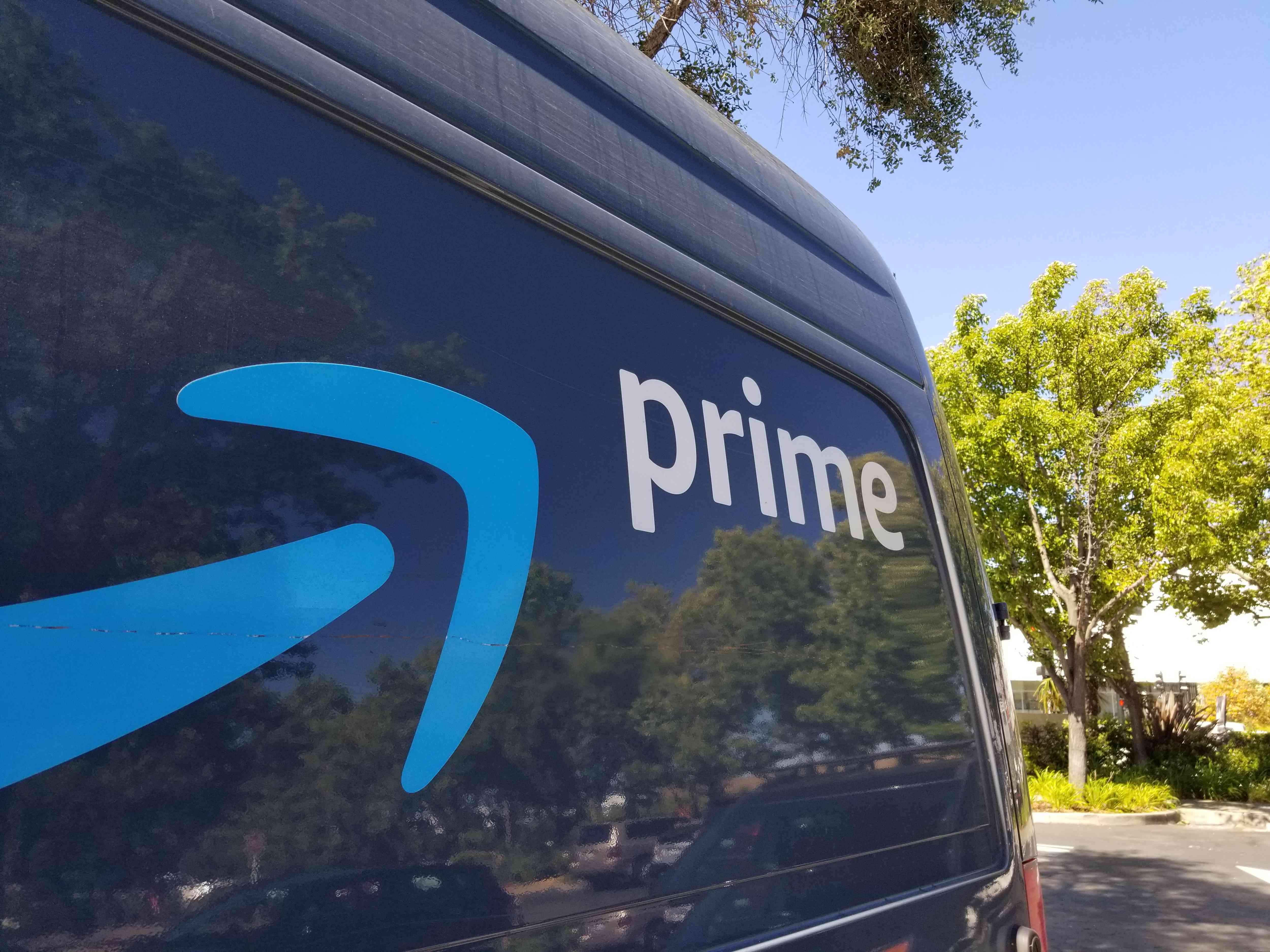 Close-up of logo for Amazon Prime service on a branded delivery truck.