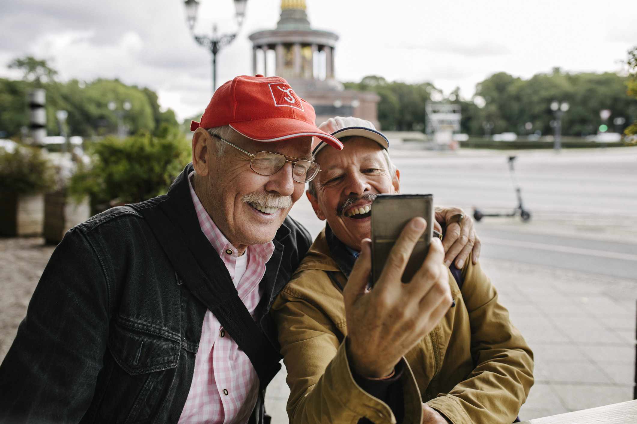 Two older men taking a photo together
