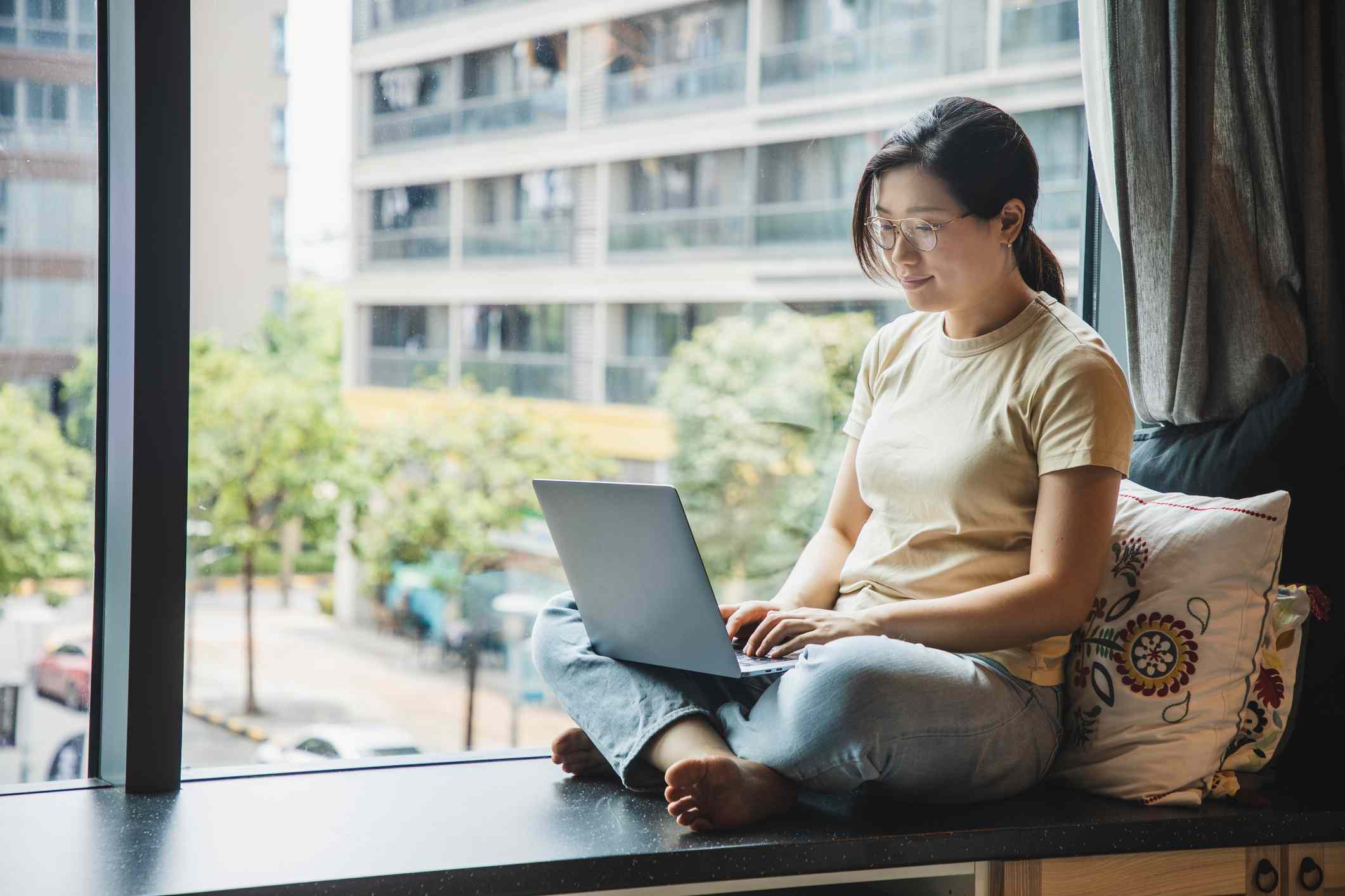 Asian Woman Sitting With Laptop Computer