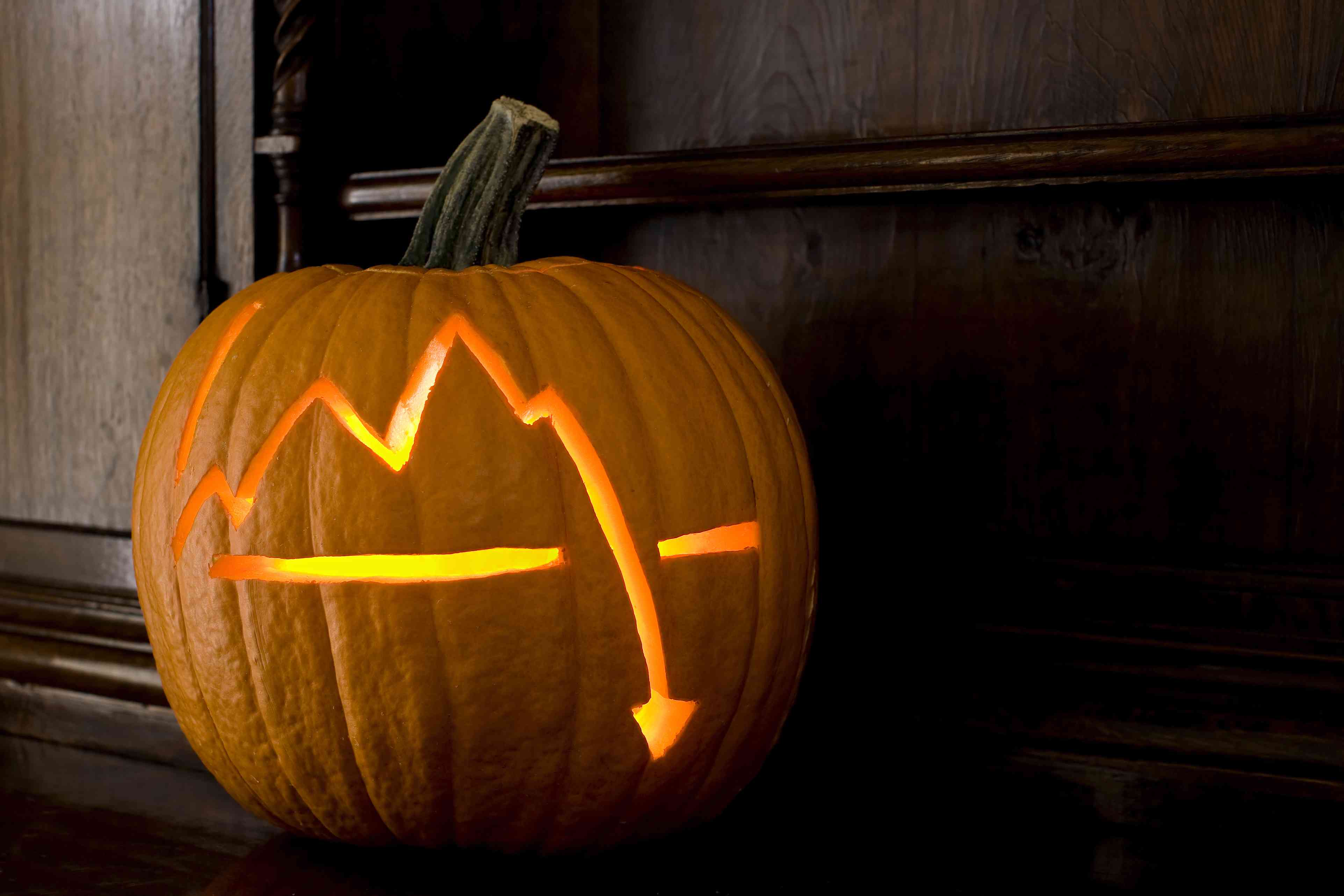 Stock market crash chart on Halloween pumpkin.