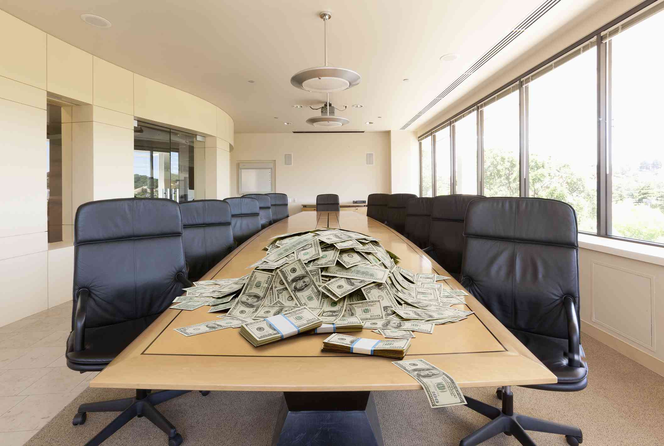 A pile of dollars on conference table.