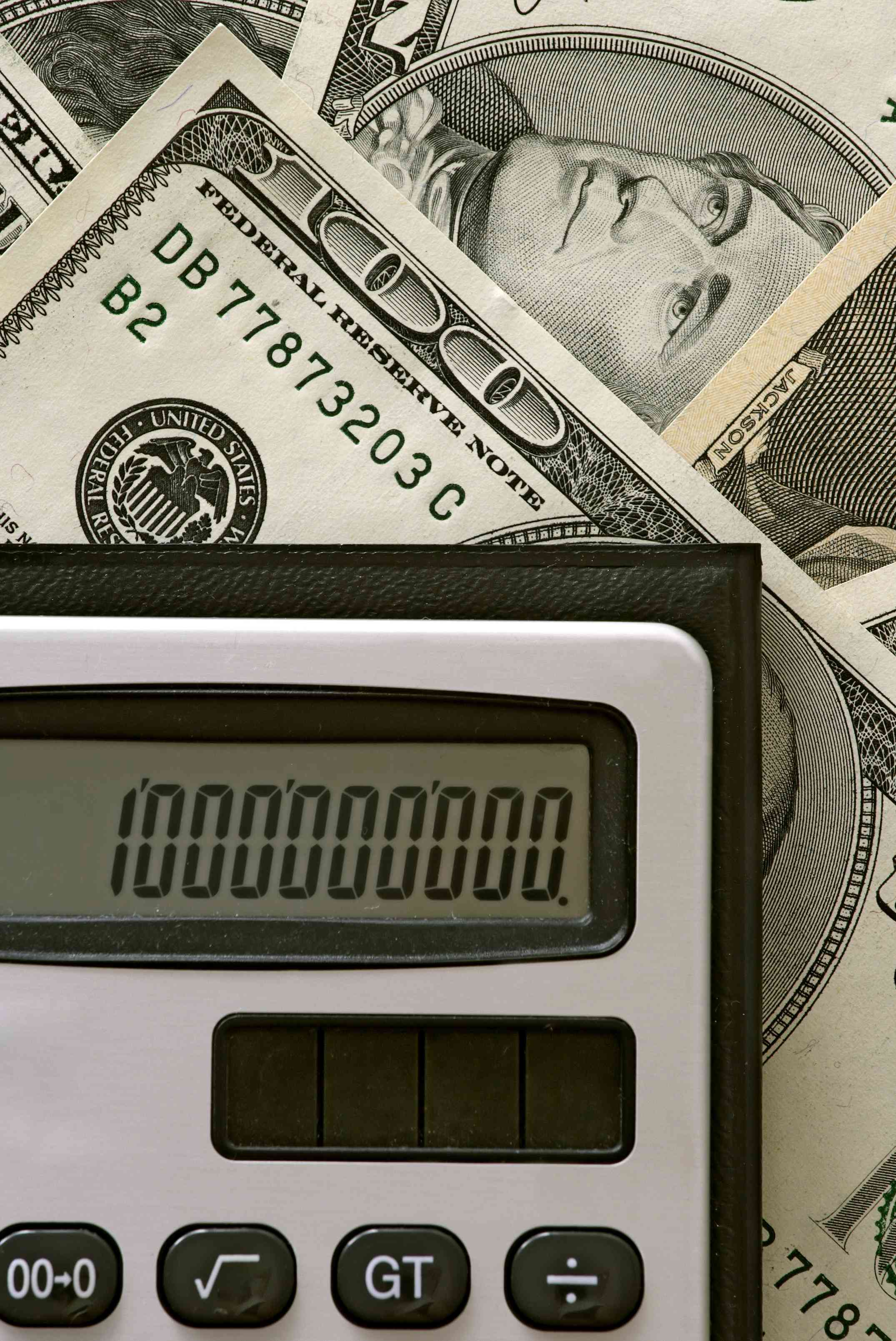 United States dollars and a calculator showing 1,000,000,000.