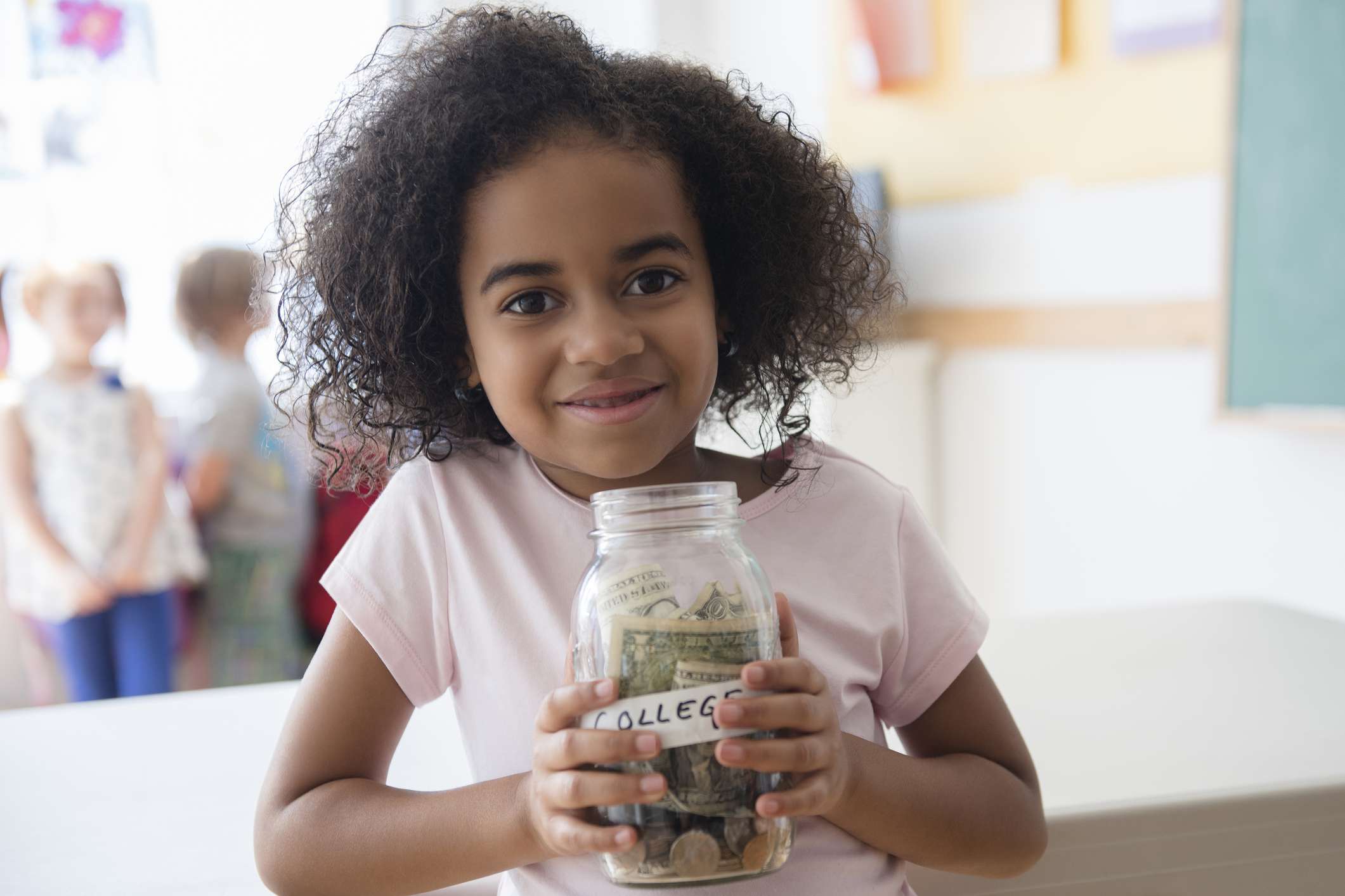 Little girl with money jar labeled "college"