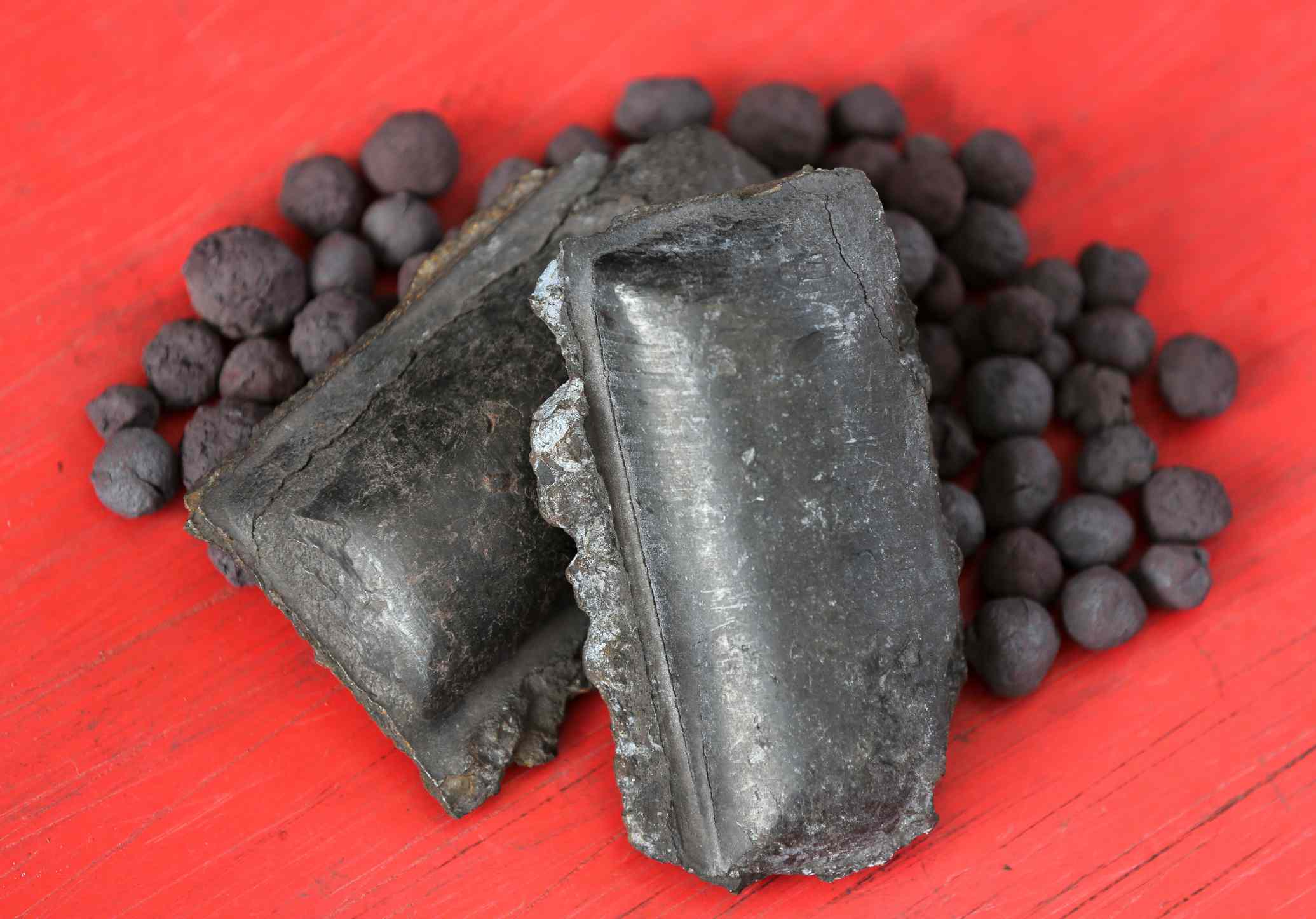 Hot briquetted iron (HBI) and iron ore pellets stand on display.