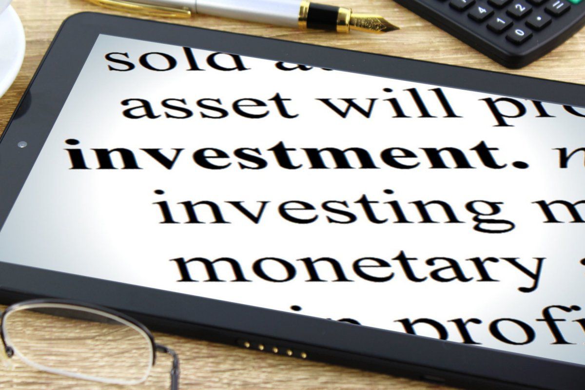 Tablet displaying investment phrases in large type.