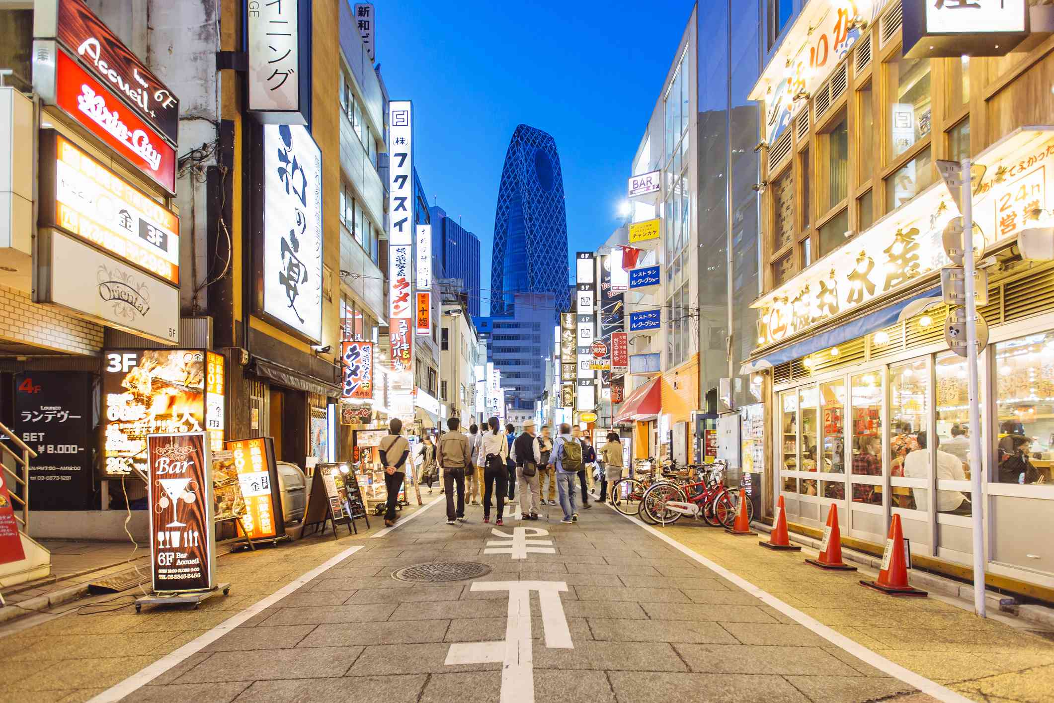 Street with shops and restaurants in Shinjuku district in Tokyo, Japan